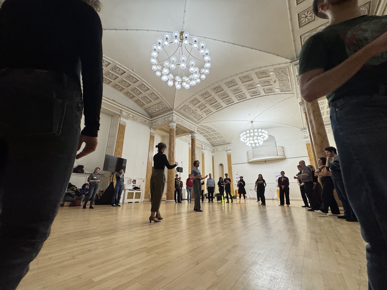 A photo of a Andrew and Lydia teaching in the Pillar Room